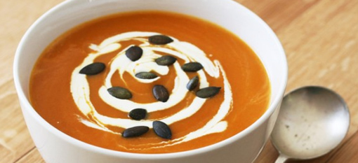 Pumpkin soup with thai red curry and smoked pumpkin seeds photo