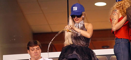 Lady Gaga Pours Champagne Over the Railing at a Sports Game photo