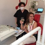Brooke Shields raises full glass of wine as she visits the dentist to treat painful Bruxism photo