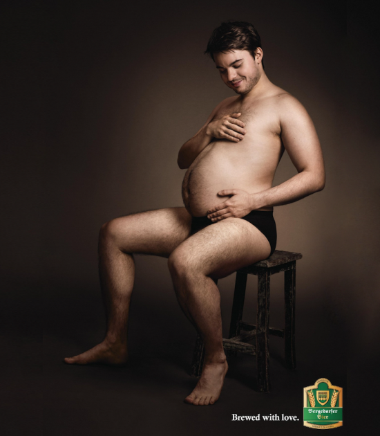 This Beer Ad Shows Men Cradling Their Beer Bellies Like Pregnant Moms photo