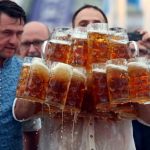 German taxman breaks record for carrying 29 beer mugs in one go photo