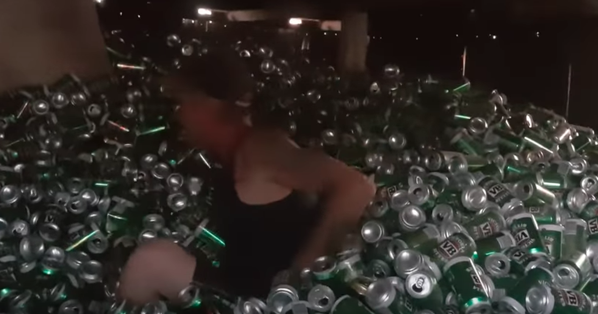 Dude Swims In His Ball Pit Full Of 30,000 Beer Cans photo