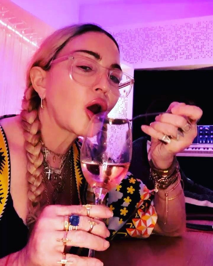 Madonna drinks wine out of a spoon photo