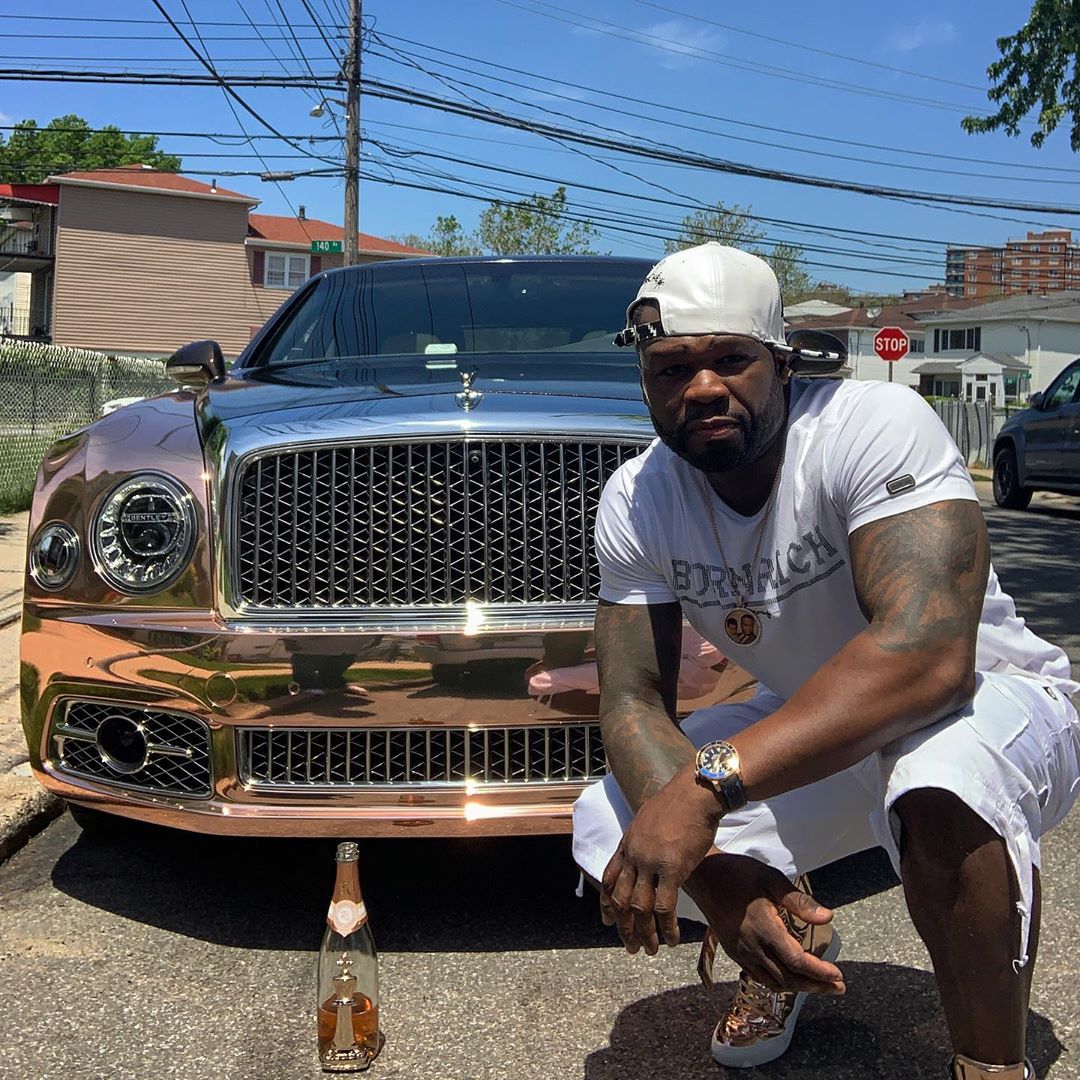 50 Cent Washes Bentley Wheels With Champagne photo