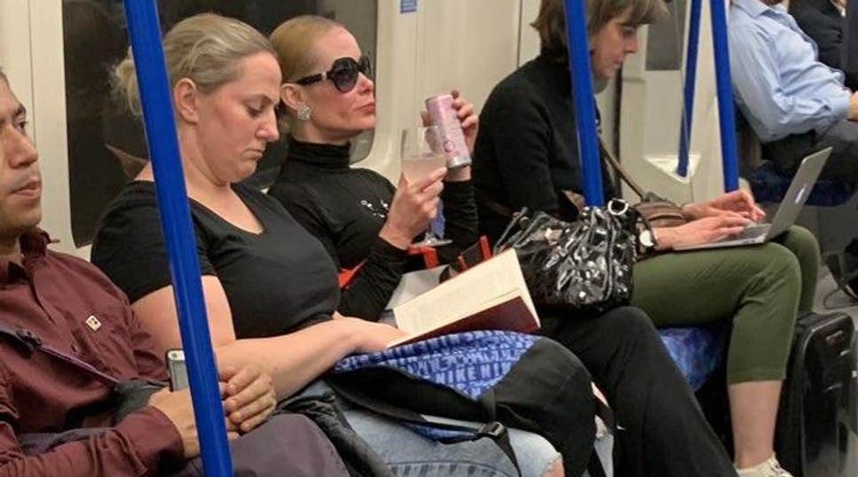 Woman In Sunglasses Drinking Gin From Glass On Tube Goes Viral photo