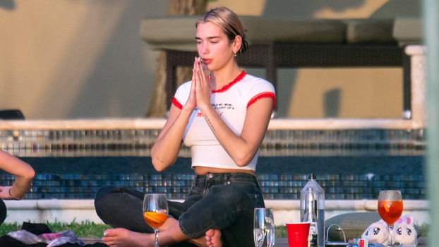 Dua Lipa. Doing Yoga. In Jeans. With An Aperol Spritz. photo