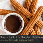 Churros Dunked In Chocolate Chili Sauce photo